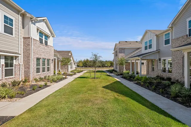 a view of a house with a yard and sitting area