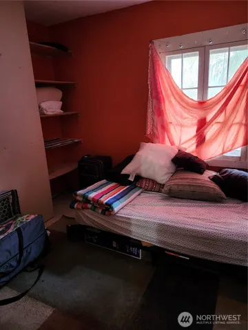 a bedroom with a bed and a window