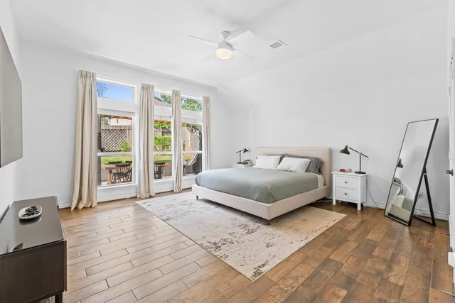 a bedroom with a bed and a large window