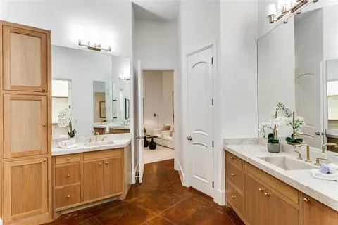 a bathroom with a tub sink and mirror
