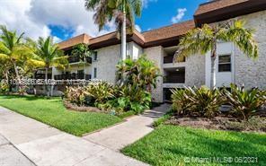 7483 Southwest 82nd Street, Unit A207 Miami, FL 33143 - Photo 1 of 27 a front view of a house with a garden