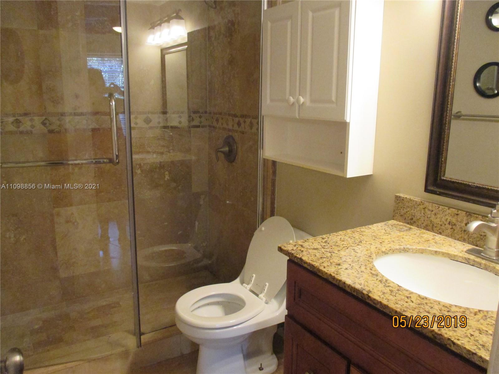 7483 Southwest 82nd Street, Unit A207 Miami, FL 33143 - Photo 11 of 27 a bathroom with a granite countertop sink toilet and shower