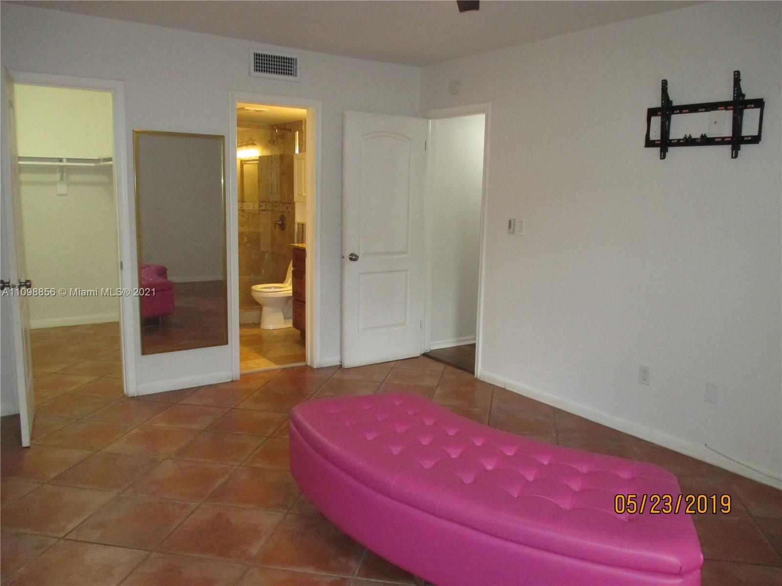 7483 Southwest 82nd Street, Unit A207 Miami, FL 33143 - Photo 13 of 27 a bedroom with a bed and a mirror