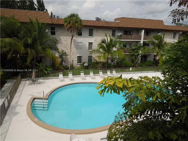 7483 Southwest 82nd Street, Unit A207 Miami, FL 33143 - Photo 17 of 27 a view of a swimming pool with an outdoor space and seating area