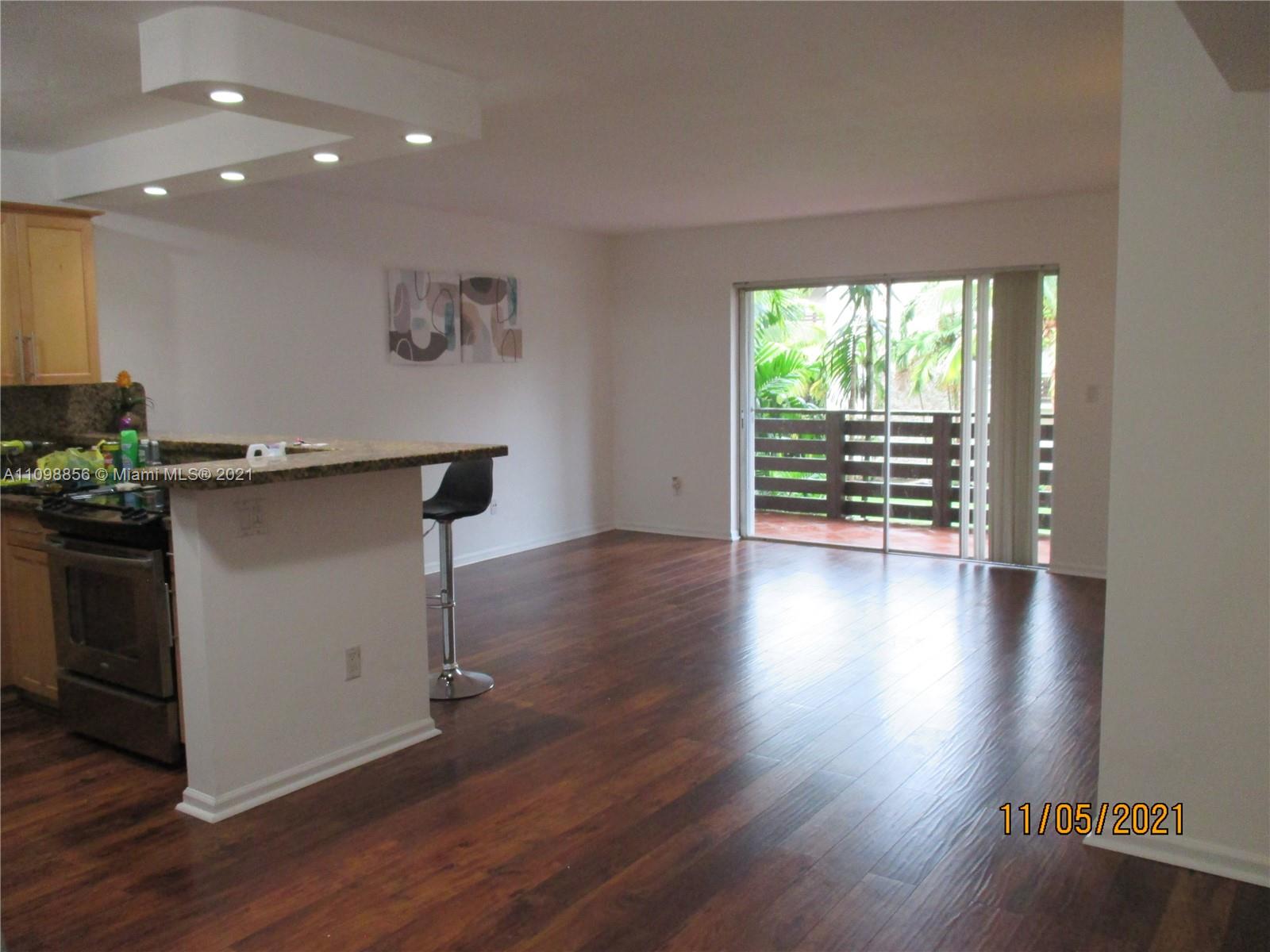 7483 Southwest 82nd Street, Unit A207 Miami, FL 33143 - Photo 2 of 27 an empty room with wooden floor and windows
