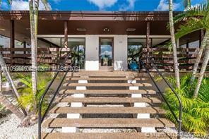 7483 Southwest 82nd Street, Unit A207 Miami, FL 33143 - Photo 22 of 27 a front view of a house with a garden
