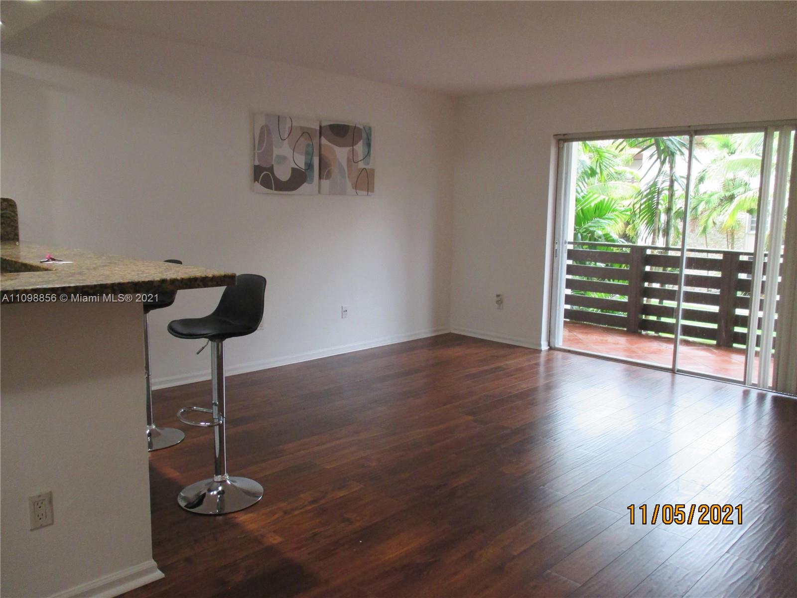 7483 Southwest 82nd Street, Unit A207 Miami, FL 33143 - Photo 25 of 27 a view of wooden floor and windows in a room