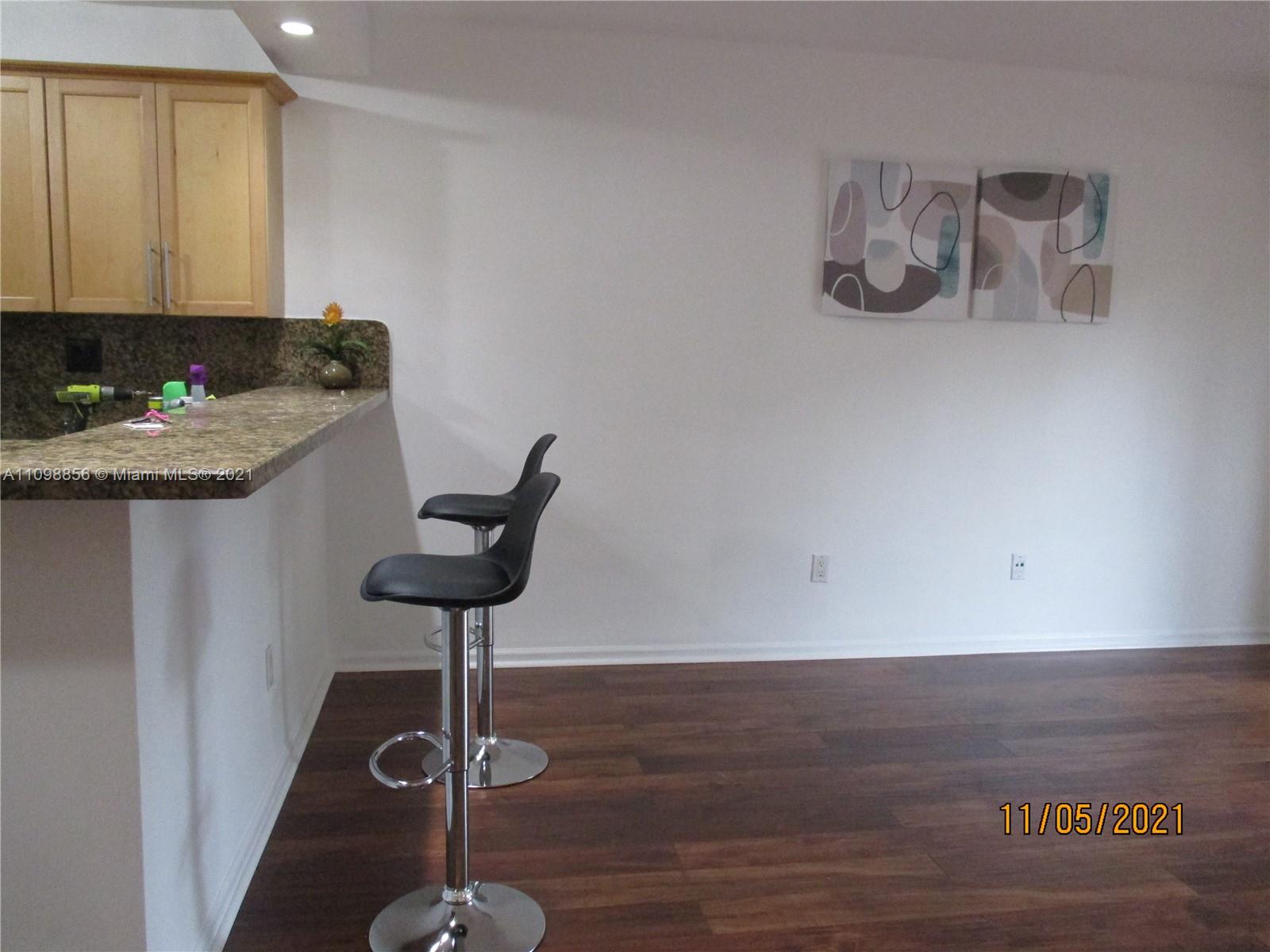 7483 Southwest 82nd Street, Unit A207 Miami, FL 33143 - Photo 4 of 27 a kitchen with a sink cabinets and wooden floor