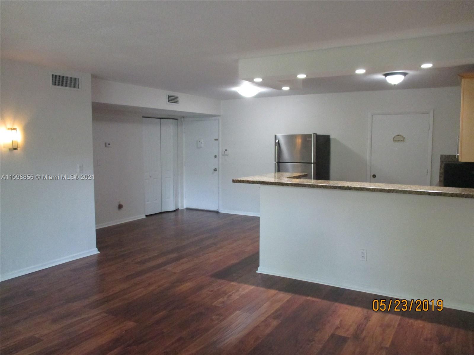 7483 Southwest 82nd Street, Unit A207 Miami, FL 33143 - Photo 6 of 27 a view of a kitchen with a sink and a microwave