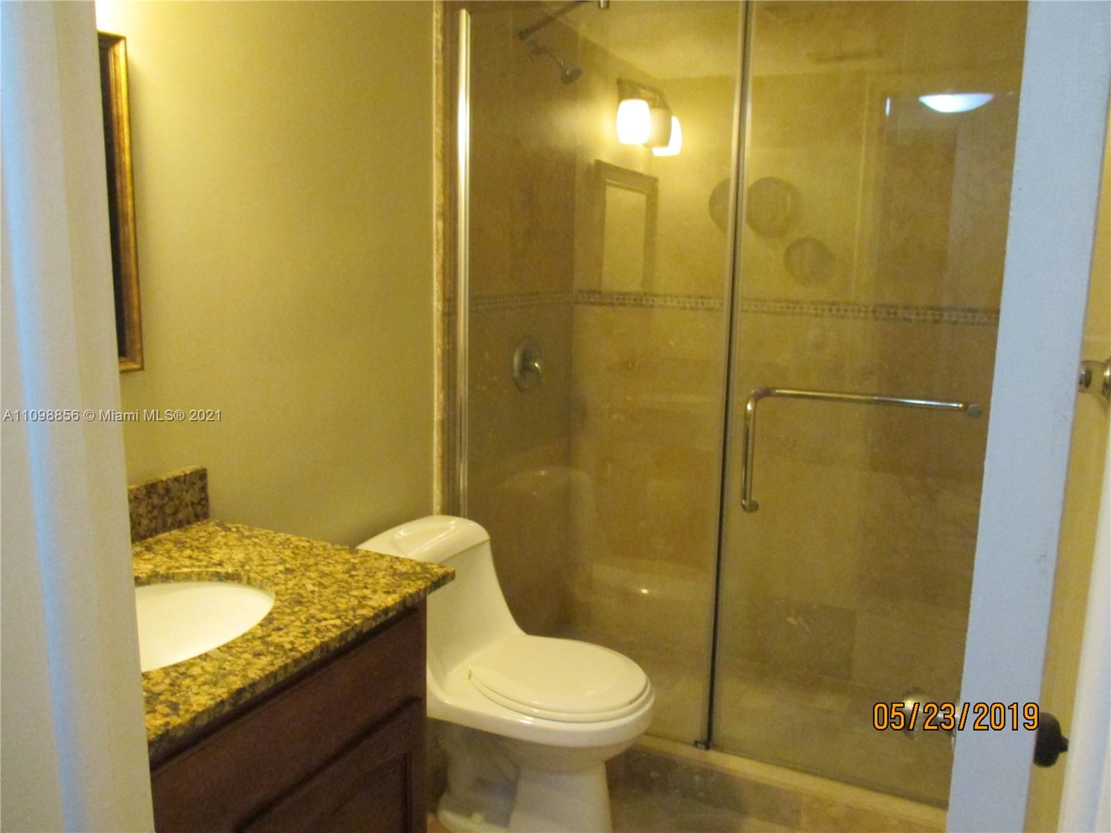 7483 Southwest 82nd Street, Unit A207 Miami, FL 33143 - Photo 9 of 27 a bathroom with a granite countertop sink toilet and shower