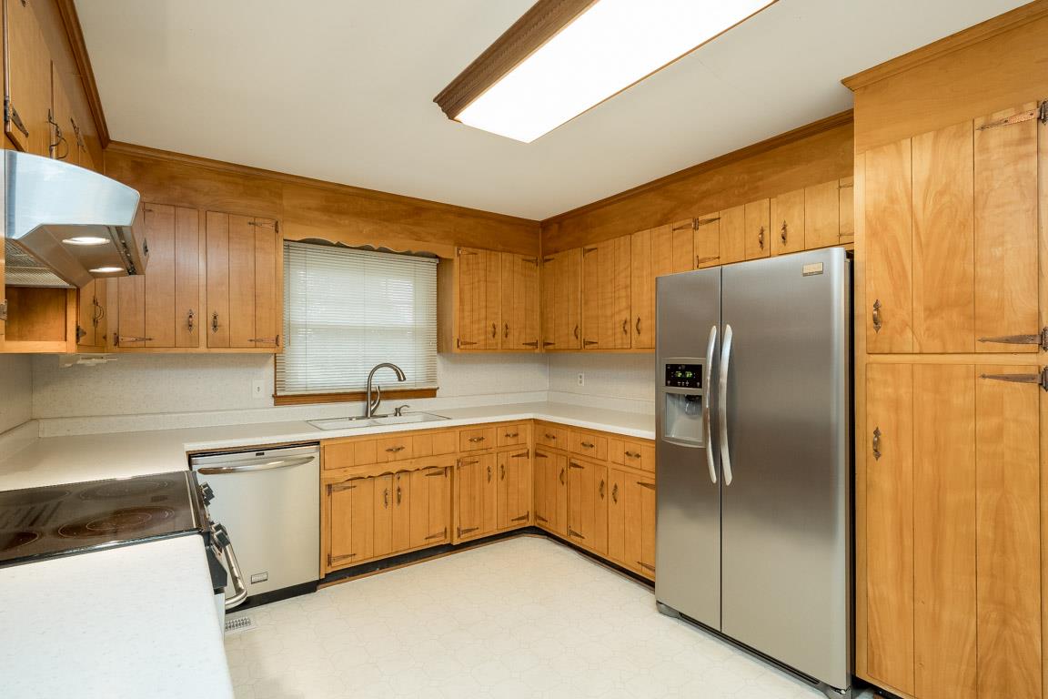 4125 Cross Plains Road Springfield, TN 37172 - Photo 14 of 30 a kitchen with stainless steel appliances granite countertop a refrigerator a sink and white cabinets
