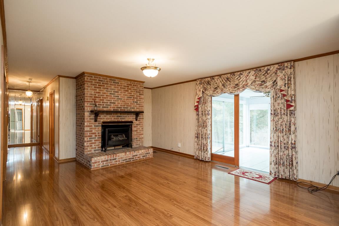 4125 Cross Plains Road Springfield, TN 37172 - Photo 8 of 30 an empty room with wooden floor fireplace and windows