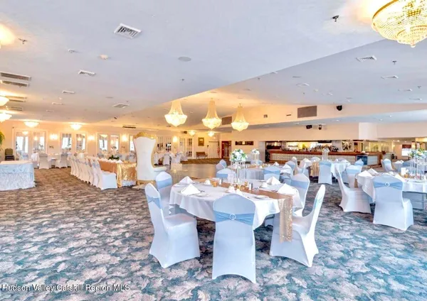 a view of a living room and chandelier