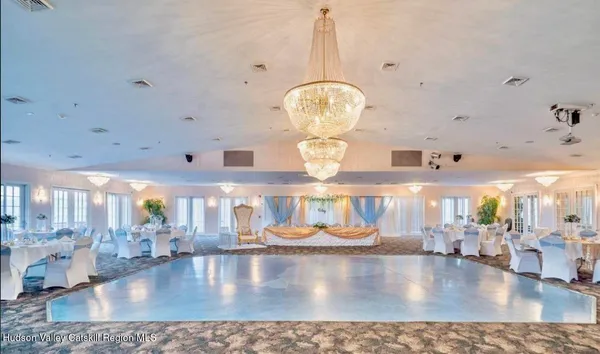 a large living room with lots of furniture and chandelier