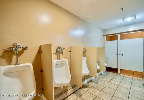 a bed room with a bed and a chair