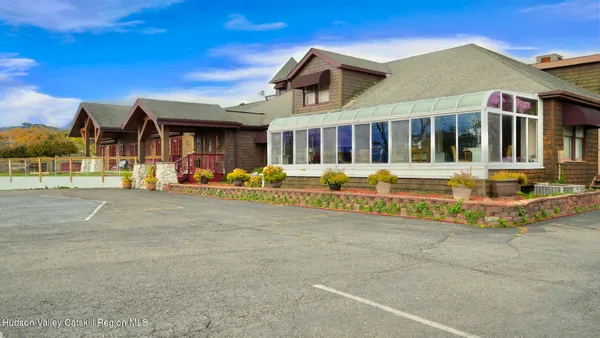 a front view of a building with a garden