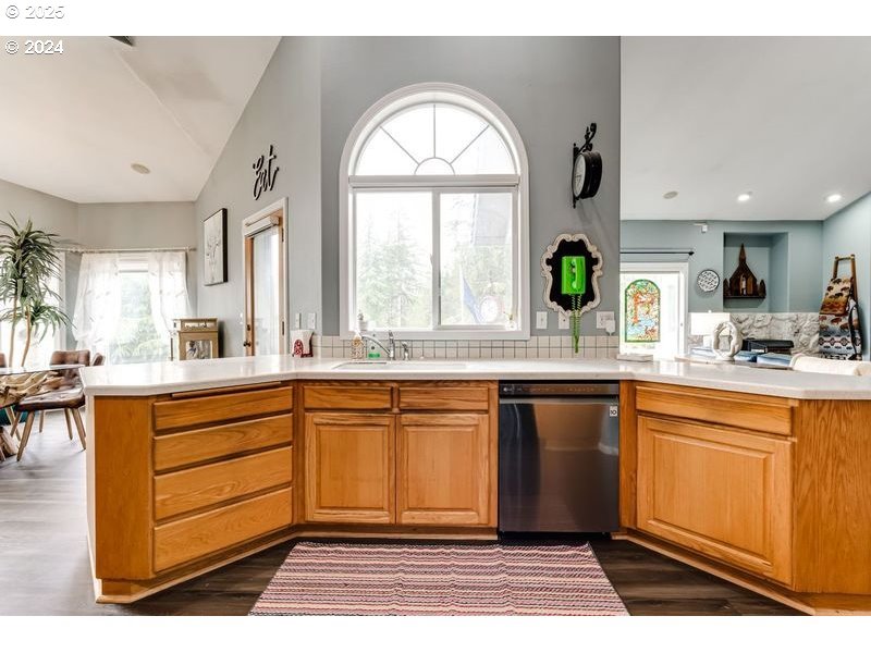 36 Ocean Dunes Drive Florence, OR 97439 - Photo 12 of 40 a large kitchen with stainless steel appliances a large window a sink and a counter space