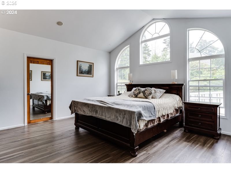 36 Ocean Dunes Drive Florence, OR 97439 - Photo 23 of 40 a spacious bedroom with a bed and a window