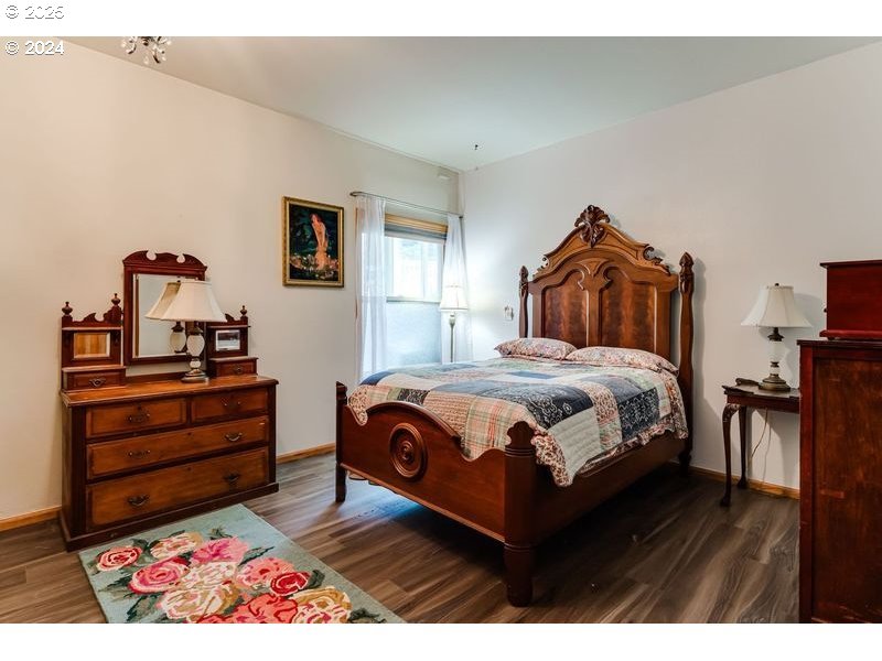 36 Ocean Dunes Drive Florence, OR 97439 - Photo 33 of 40 a bedroom with a bed and wooden floor