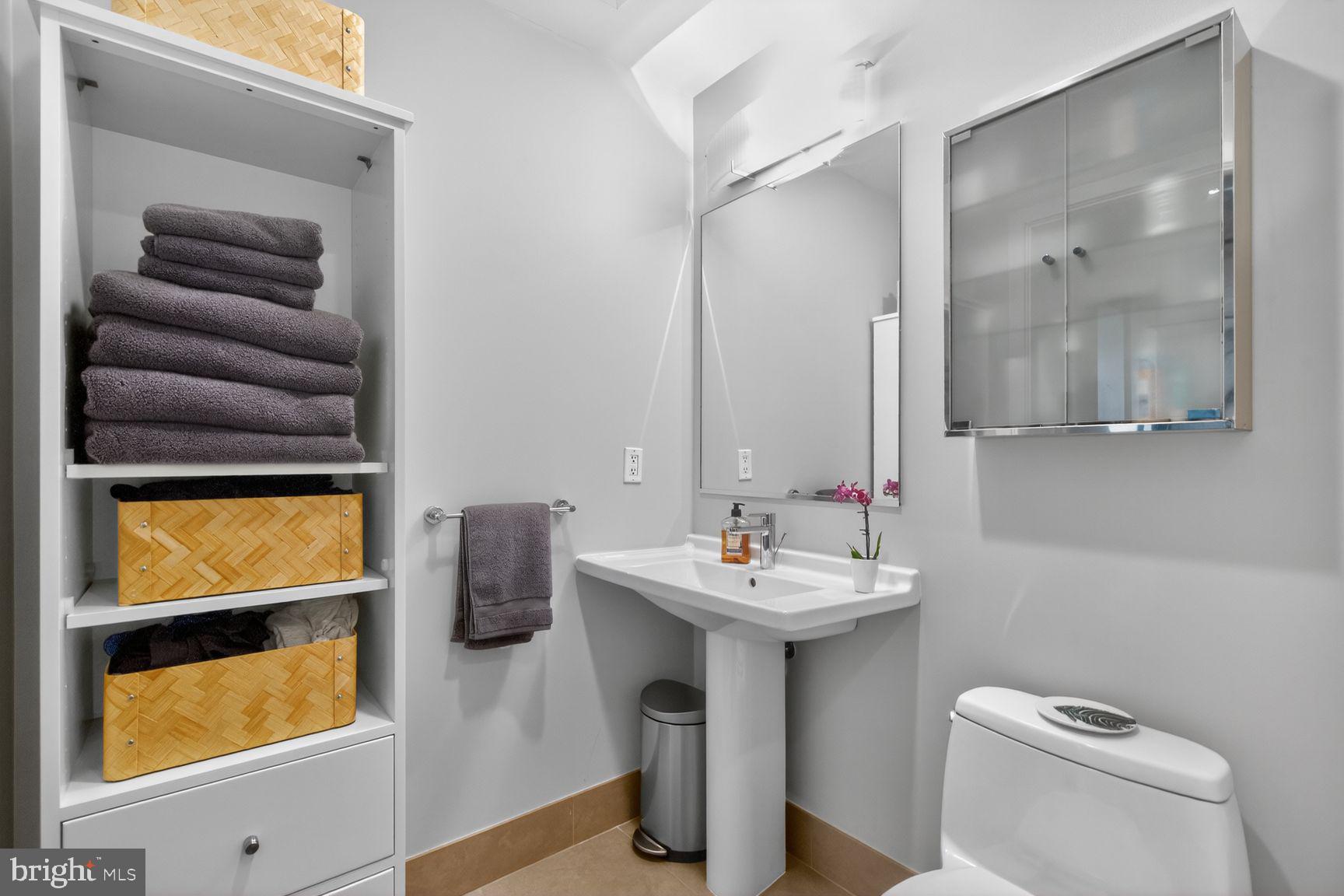 2125 14th Street Northwest, Unit 531 Washington, DC 20009 - Photo 14 of 20 a bathroom with a toilet sink and mirror