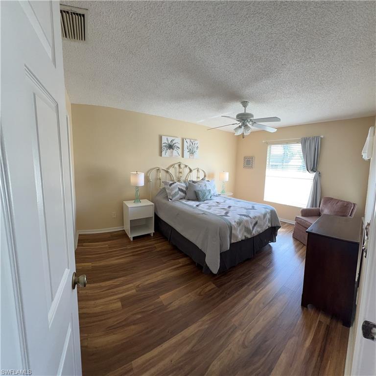 185 Grand Oaks Way, Unit R204 Naples, FL 34110 - Photo 15 of 18 a spacious bedroom with a bed and window