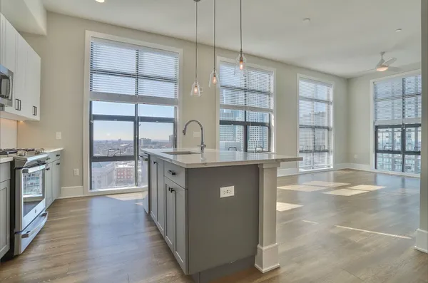a kitchen with counter top space and windows