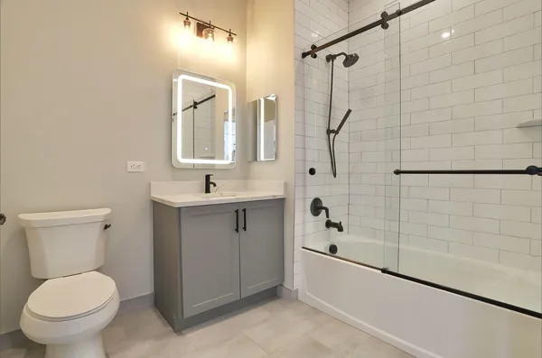 a bathroom with a toilet sink and shower