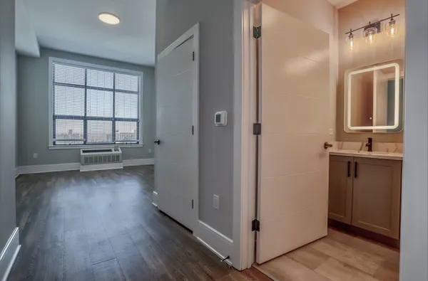 a view of a hallway with wooden floor