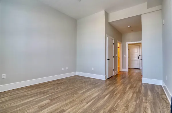 a view of a room with wooden floor