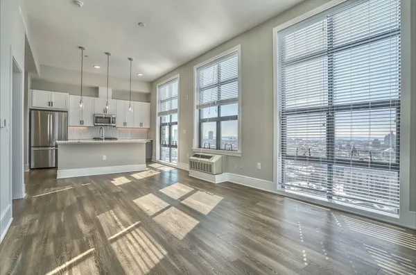 a open kitchen with stainless steel appliances granite countertop a refrigerator and wooden floor