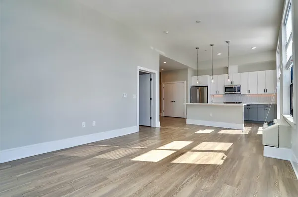 a view of a kitchen with cabinets and wooden floor