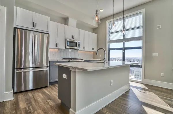 a kitchen with stainless steel appliances a refrigerator and a sink