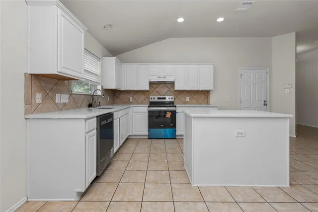 a kitchen with stainless steel appliances a refrigerator sink and cabinets