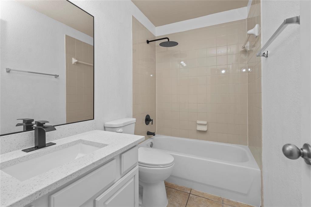 3256 Torio Grand Prairie, TX 75054 - Photo 8 of 17 a bathroom with a sink a toilet a mirror and shower