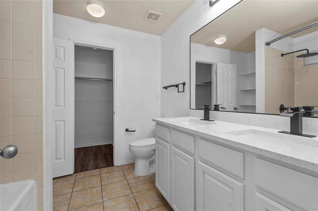 3256 Torio Grand Prairie, TX 75054 - Photo 9 of 17 a bathroom with a toilet sink and mirror