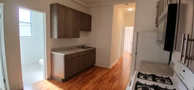 a kitchen with granite countertop a stove and a refrigerator