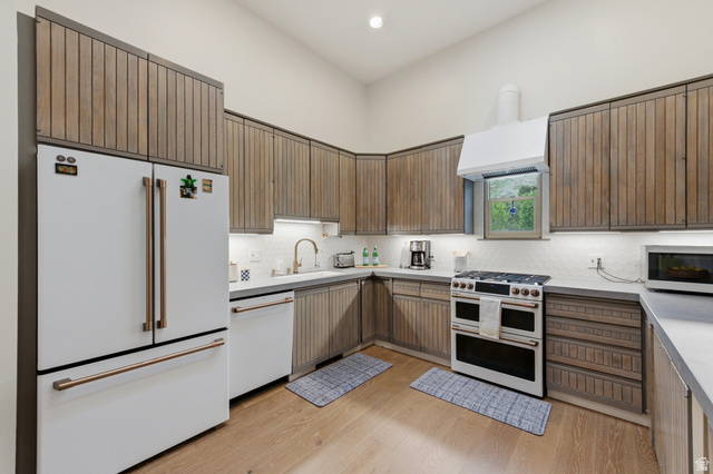 3674 Oak Rim Way Salt Lake City, UT 84109 - Photo 12 of 47 Modern kitchen with wood-finish cabinetry and light countertops