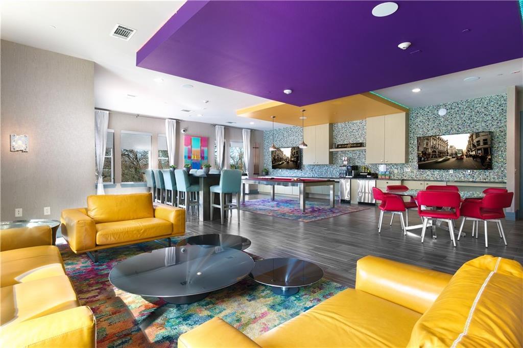 1900 Barton Springs Road, Unit 5009 Austin, TX 78704 - Photo 28 of 35 A vibrant communal space offers diverse entertainment options, from a cozy lounge area to a lively game zone.