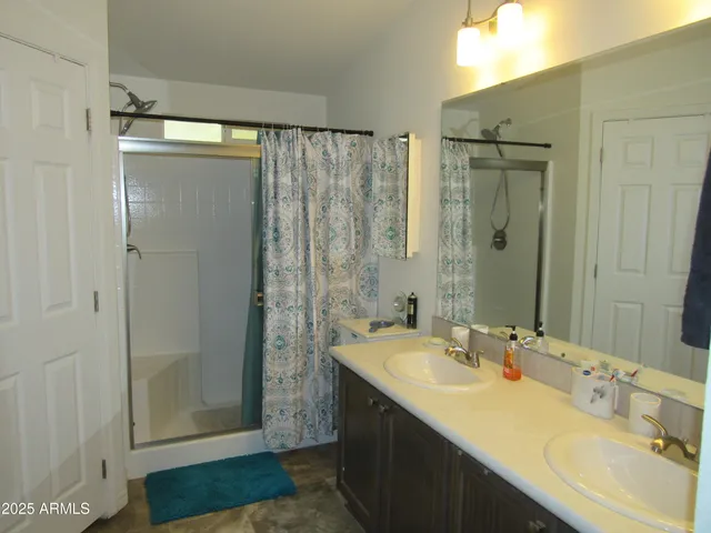 a bathroom with a shower sink and mirror