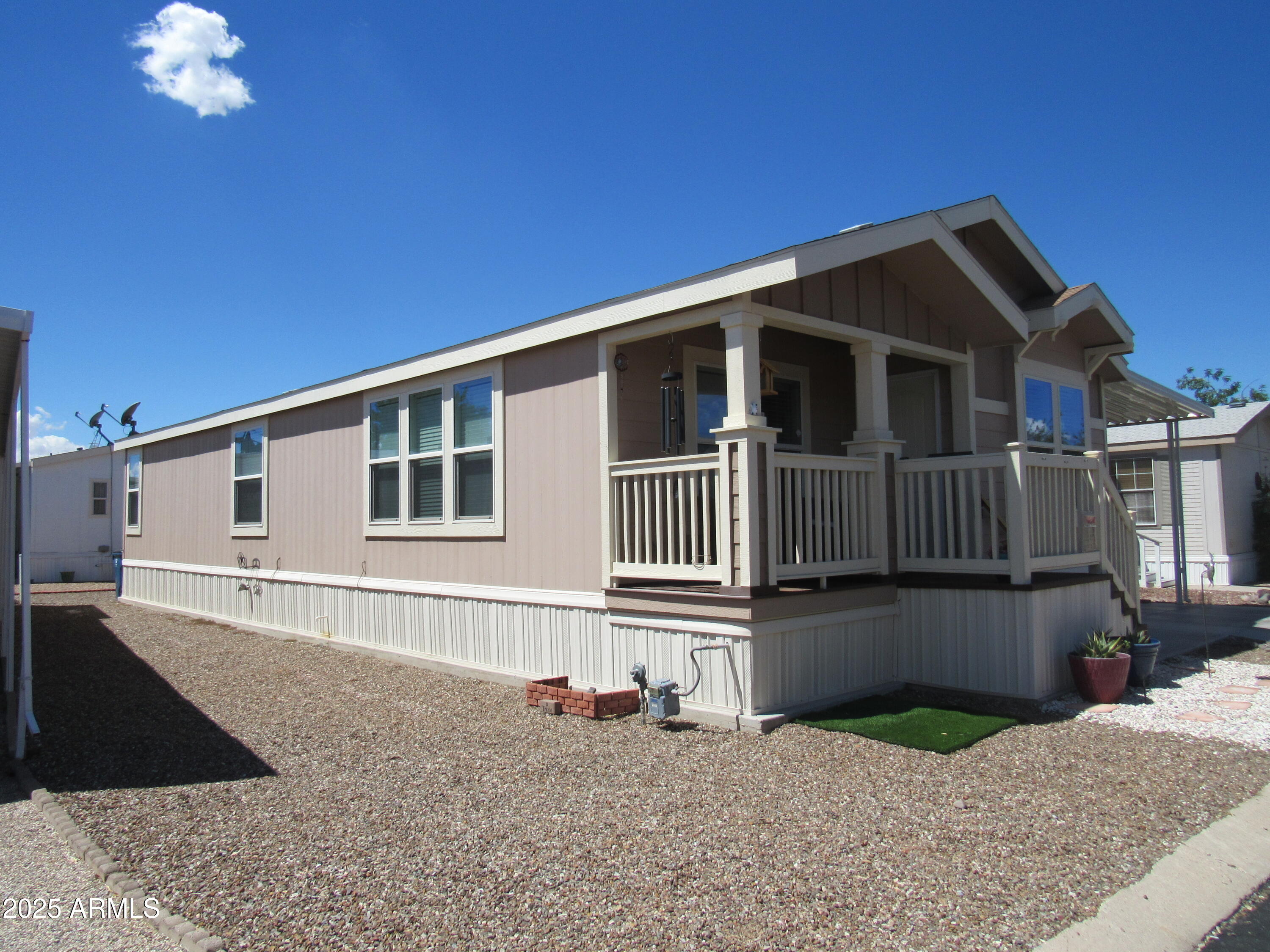 7570 East Speedway Boulevard, Unit 573 Tucson, AZ 85710 - Photo 2 of 16 a front view of a house with a yard