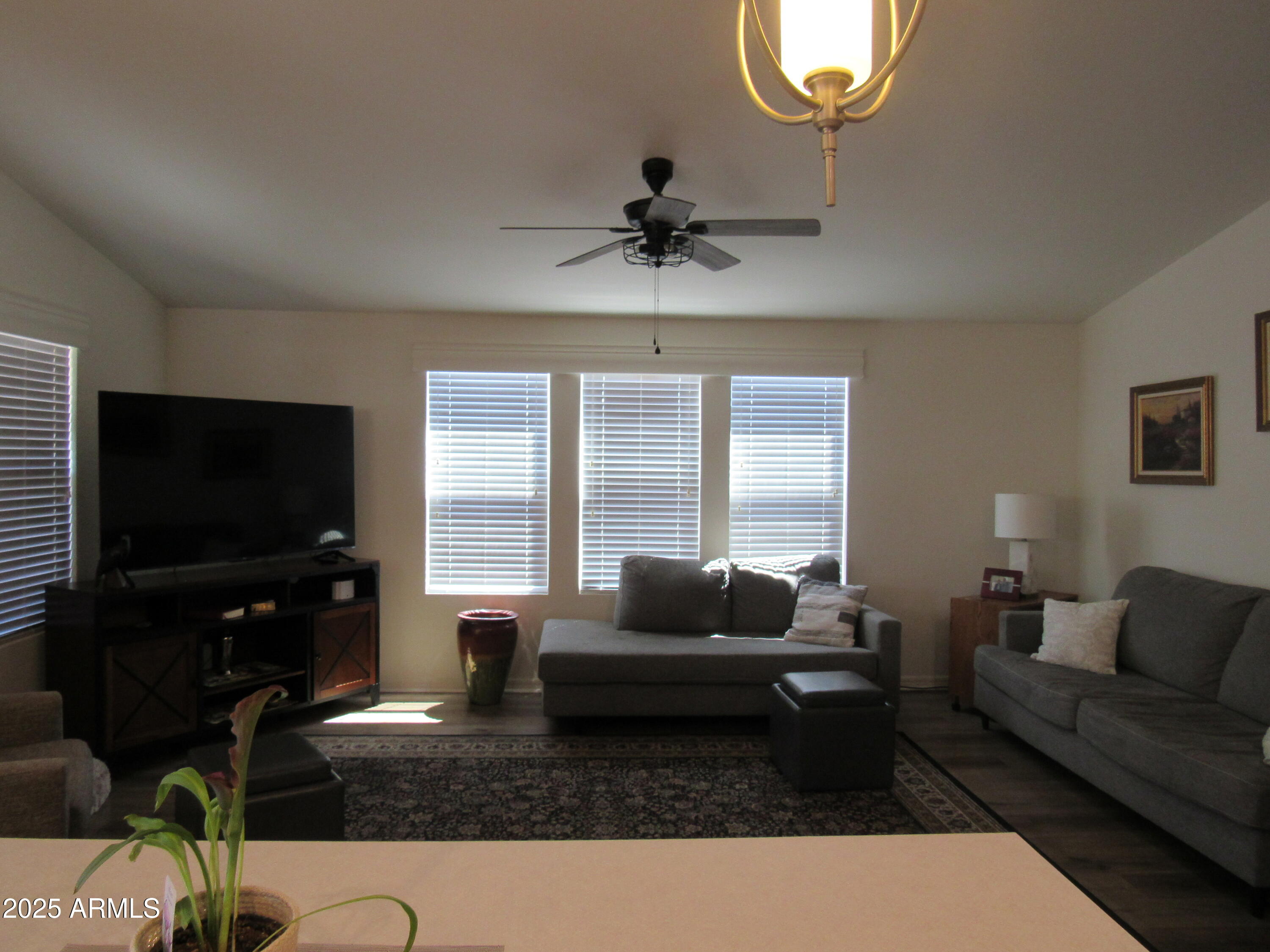 7570 East Speedway Boulevard, Unit 573 Tucson, AZ 85710 - Photo 5 of 16 a living room with furniture a flat screen tv and a large window