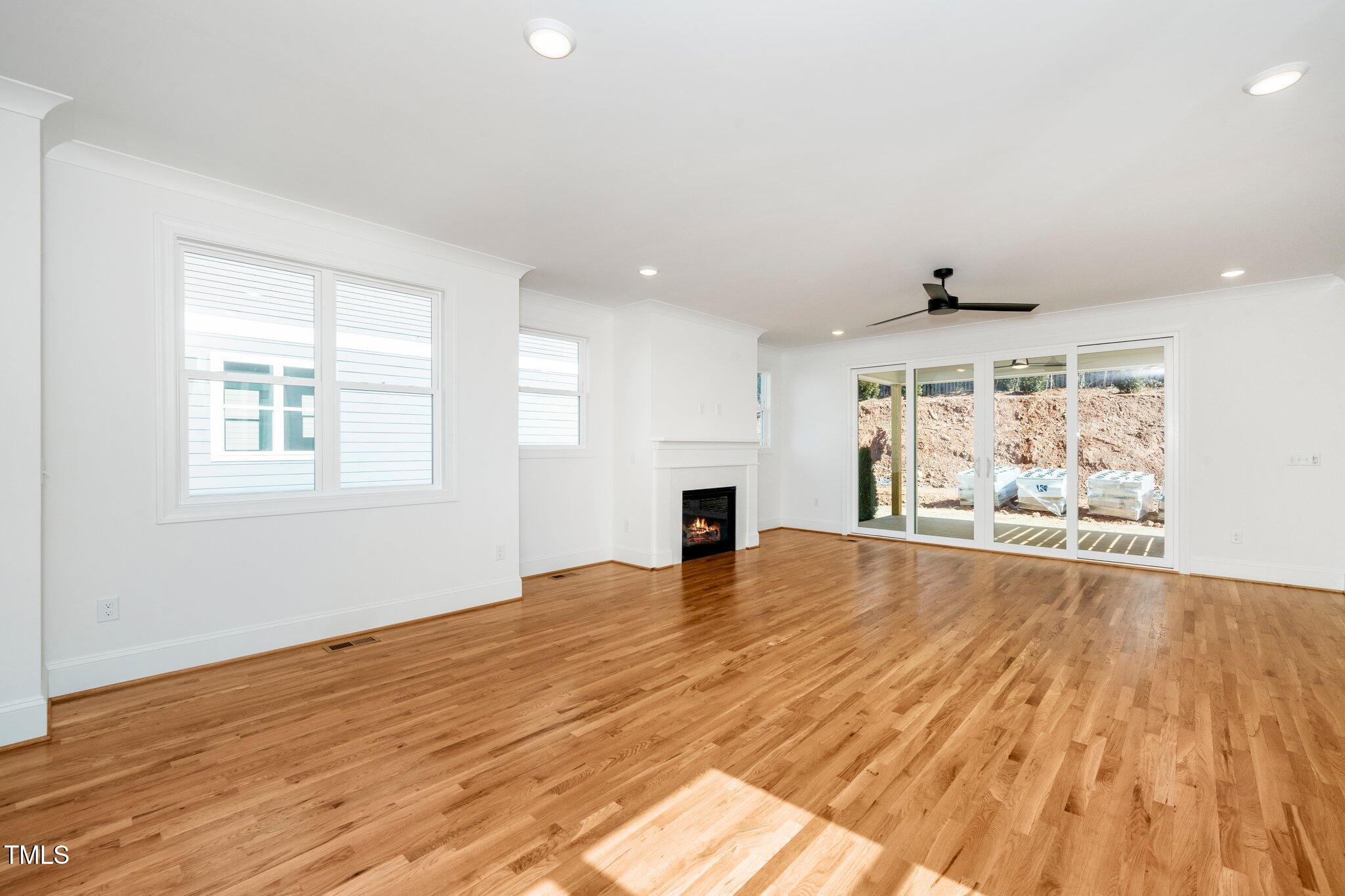 1215 Chaney Road Raleigh, NC 27606 - Photo 14 of 29 a view of an empty room with wooden floor and a window