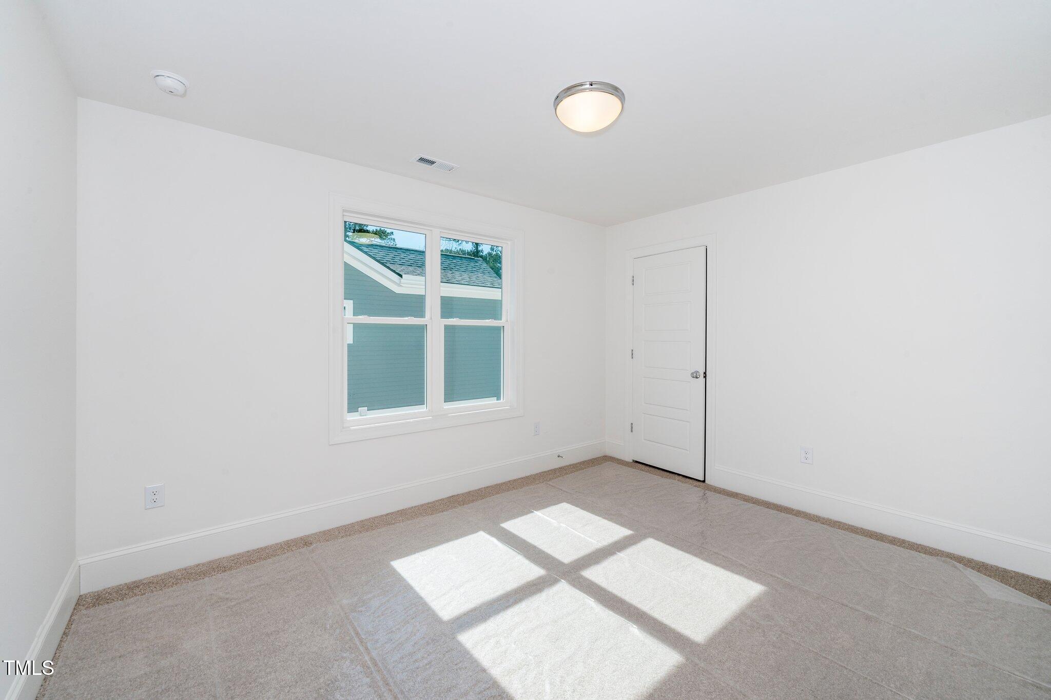 1215 Chaney Road Raleigh, NC 27606 - Photo 21 of 29 an empty room with windows