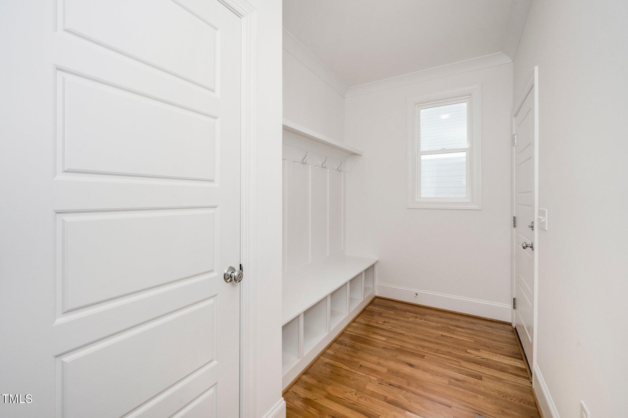1215 Chaney Road Raleigh, NC 27606 - Photo 7 of 29 a view of an empty room with wooden floor and a window