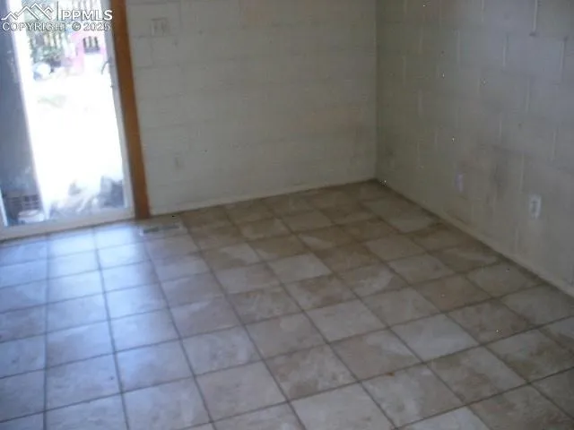 a view of a kitchen with wooden floor and electronic appliances
