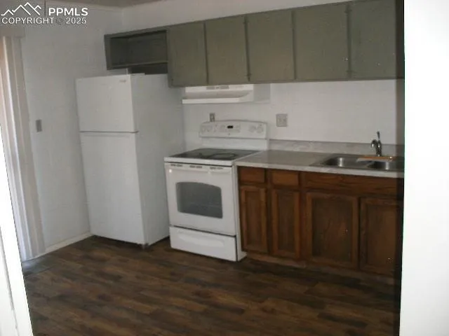 a kitchen with a sink a stove and refrigerator