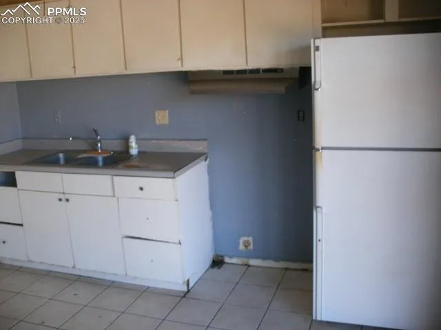 a kitchen with a sink and cabinets