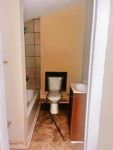 a bathroom with a toilet and a shower