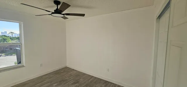 a view of a small space with wooden floor and a window