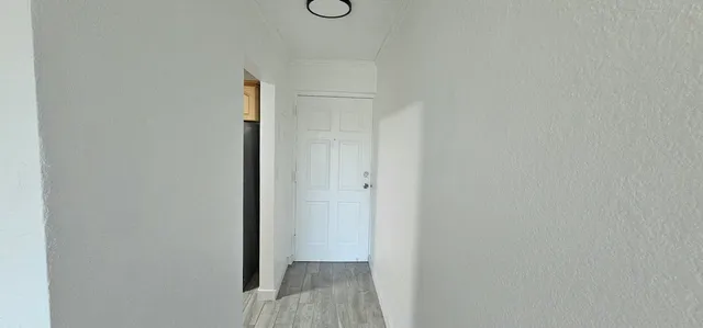 a view of hallway with wooden floor